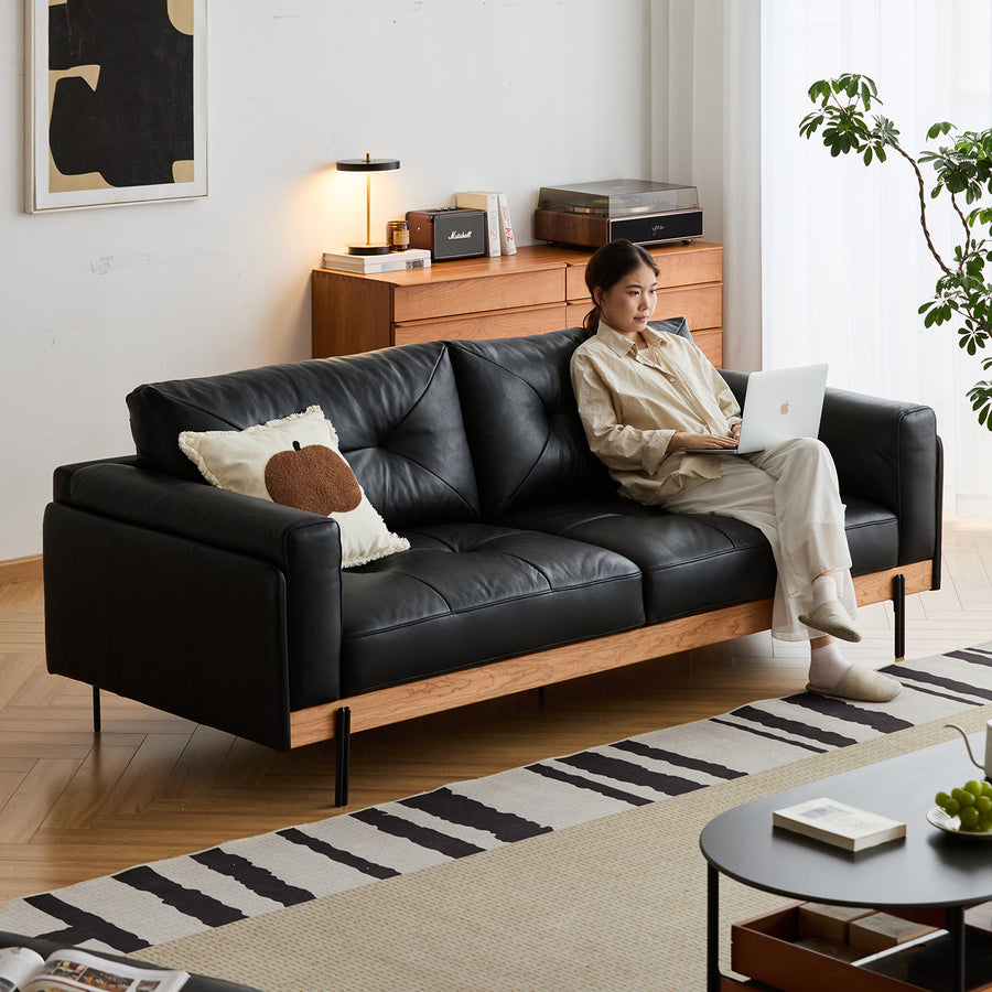 Scandinavian microfiber leather 3 seater sofa black in real life style.