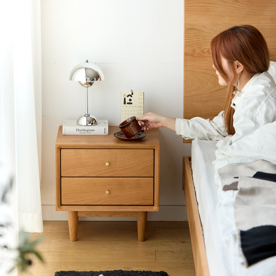 Scandinavian cherry wood side table green in real life style.