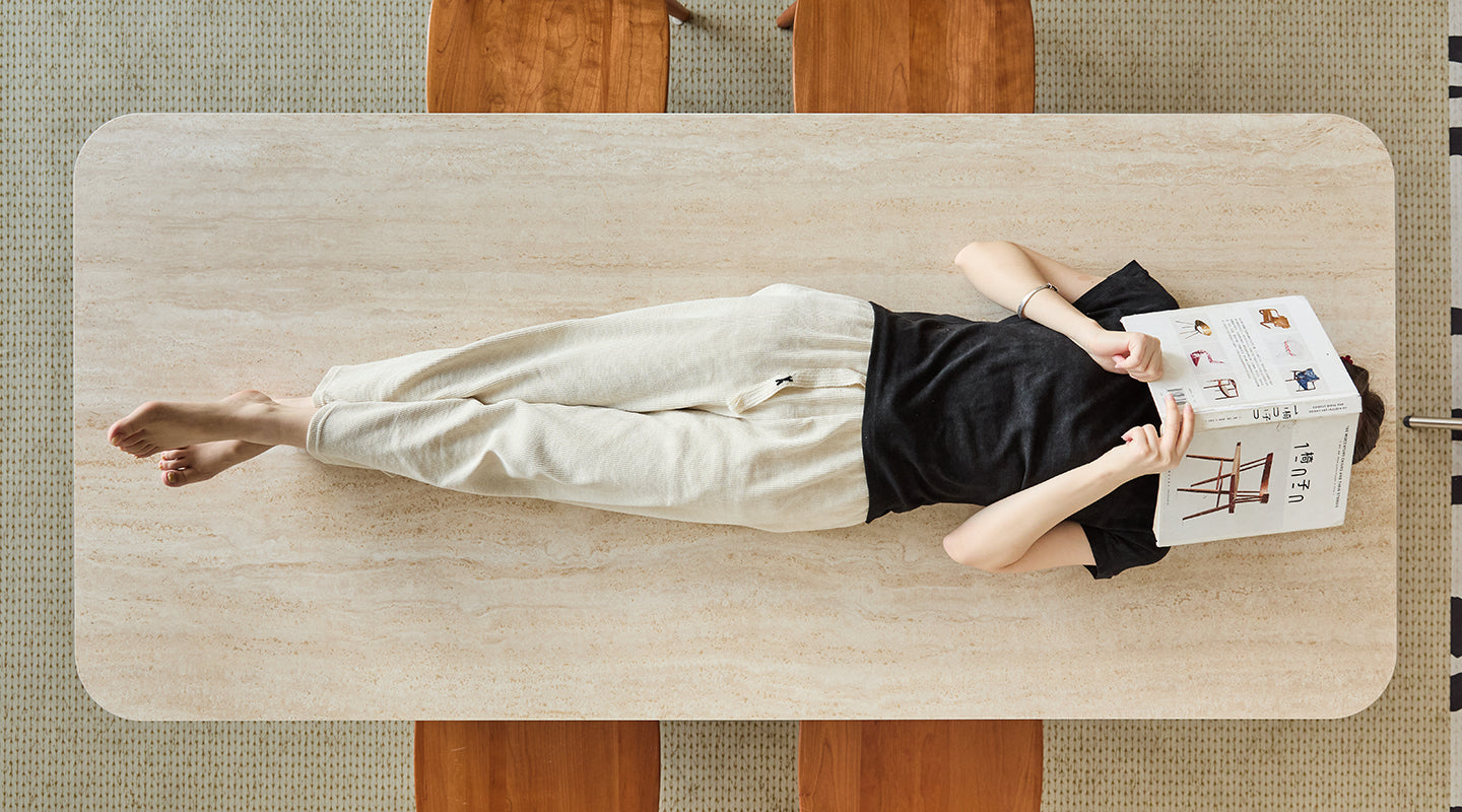 Minimalist travertine dining table with a relaxed lifestyle vibe, showcasing casual versatility for both dining and leisure.
