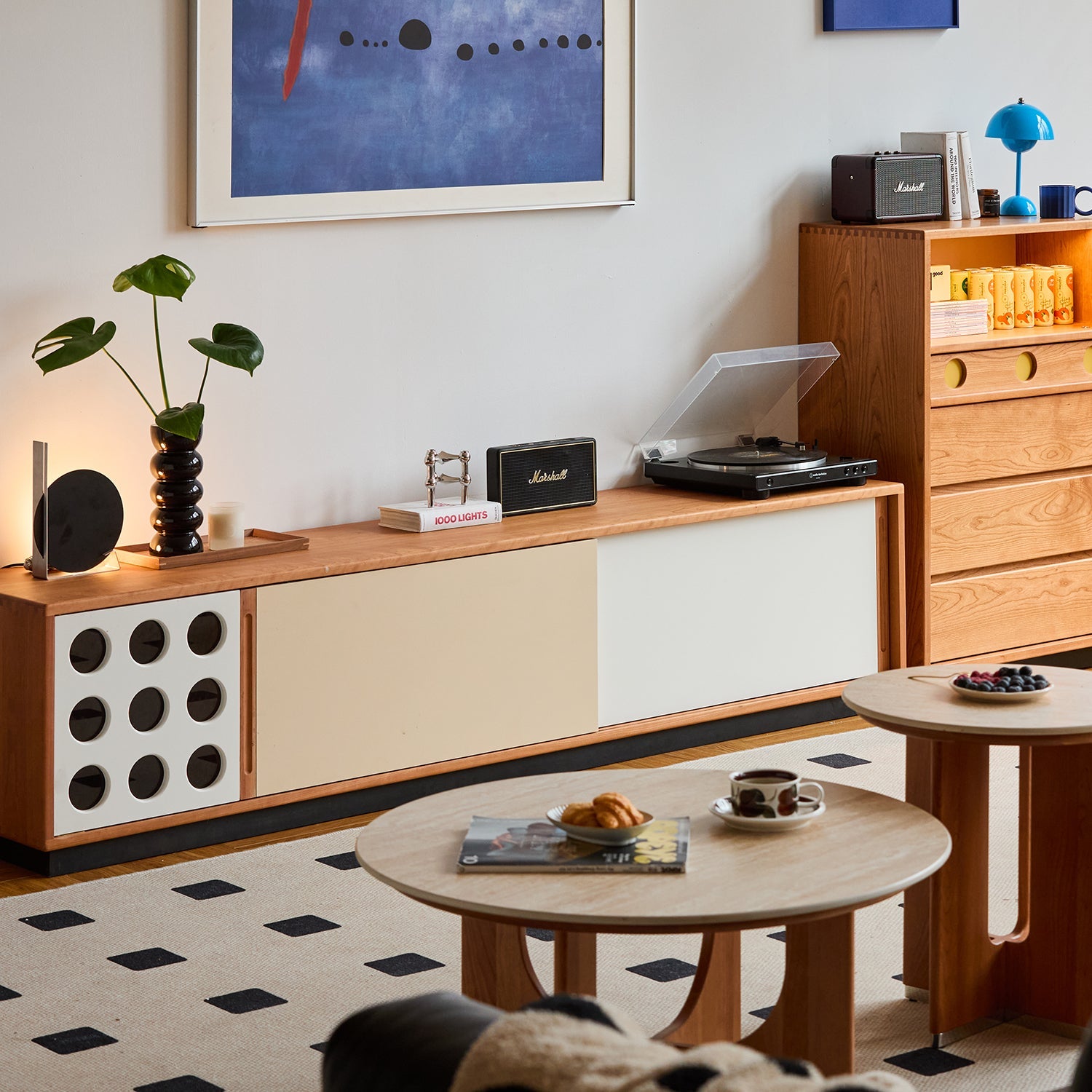 Scandinavian-style living room with minimalist wood furniture, record player, and modern decor, showcasing LOFT HOME’s cozy and functional interior setup.