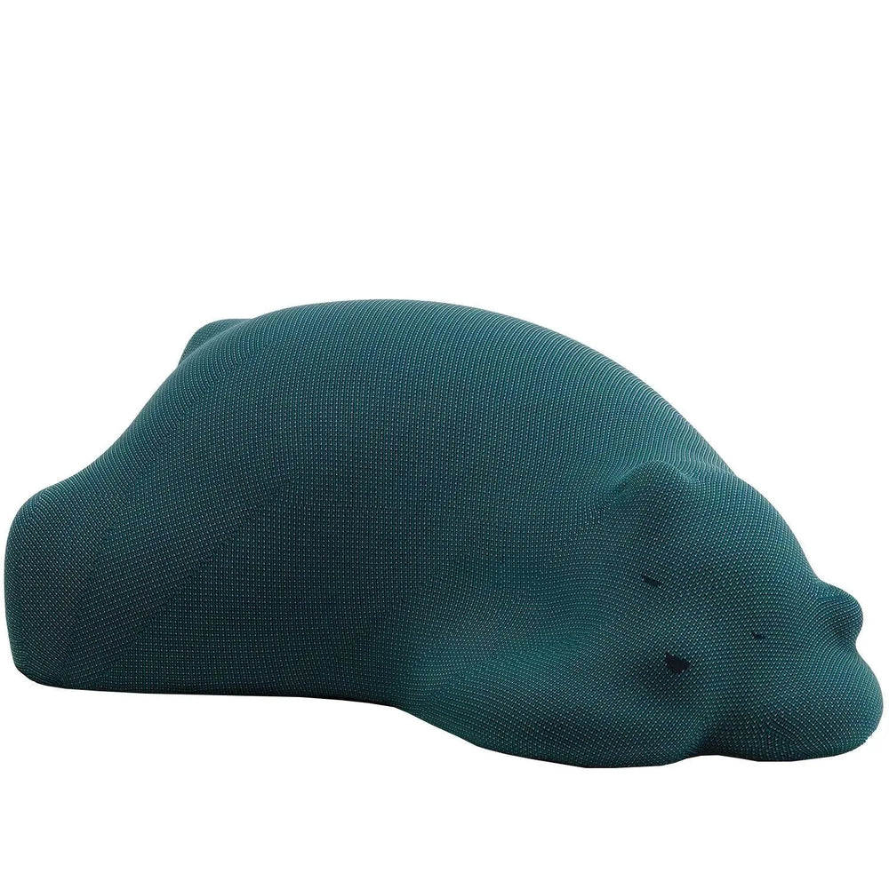 Contemporary knit fabric ottoman resting bear in white background.