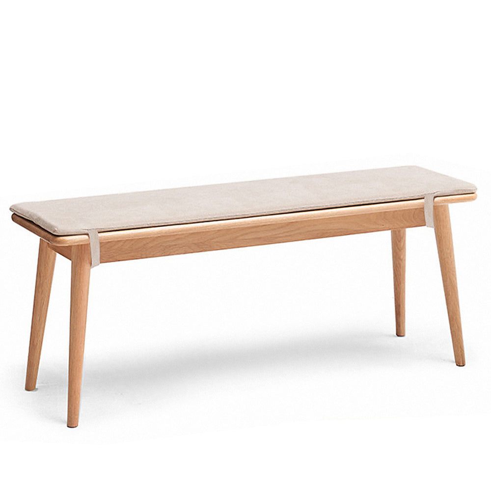 Scandinavian oak wood dining bench with cushion sereno in white background.