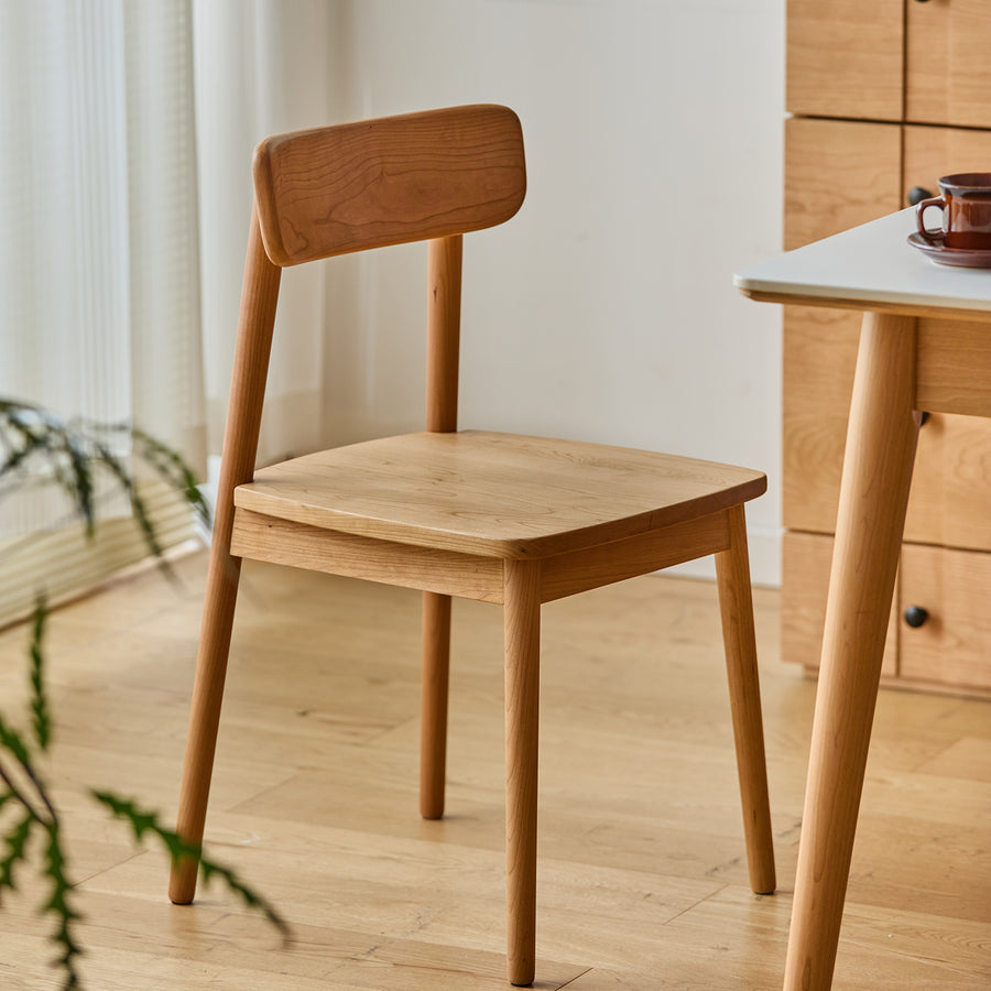 Scandinavian cherry wood dining chair green primary product view.